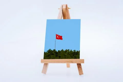 Image of Turkish  flag above trees on a painting tripod Stock Photos