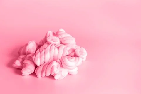 Image with twisted marshmallows is toned in pantone color of viva magenta Stock Photos