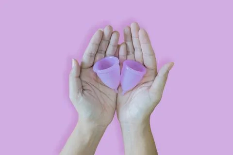 Image of two hands putting together with clean sanitary pads on palms Stock Photos