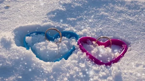The image of two of hearts in snow with wedding rings Stock Footage 101284760