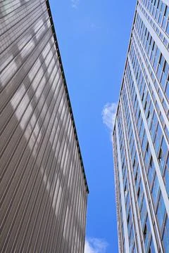 An image of two high-rise modernist buildings (skyscrapers) soaring up into.. Stock Photos
