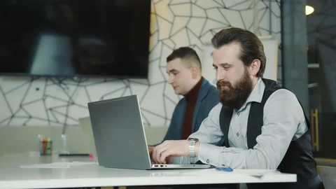 An image of two programmers working on a laptop and a tablet. Web programmers at Stock Footage 149514221
