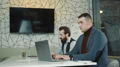 An image of two programmers working on a laptop and a tablet. Web programmers at Stock Footage 149514602