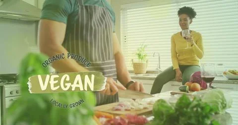 Image of vegan text over diverse couple preparing healthy meal in kitchen Ilustração Stock