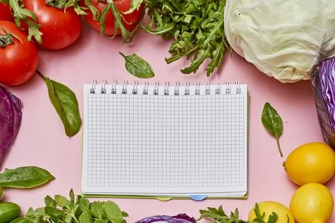 An image of vegetables and a notebook Stock Photos