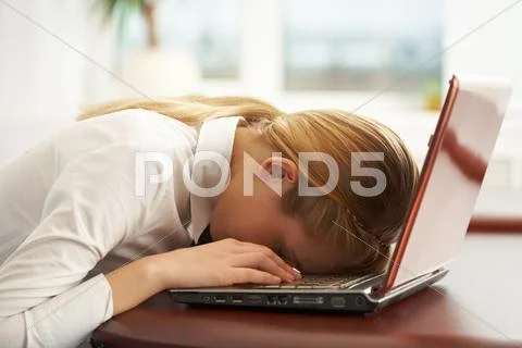 Image of very tired businesswoman or student with her face on keyboard of laptop Stock-Fotos