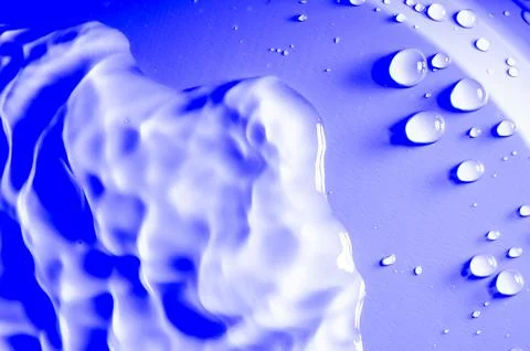The image is of water droplets on a blue surface Stock Photos