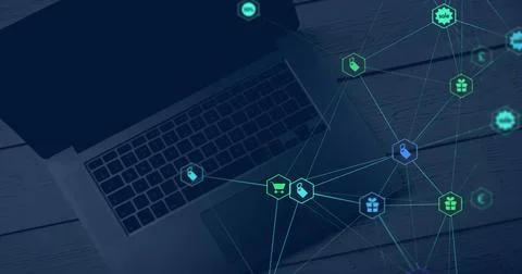 Image of web of connections with icons floating over a laptop computer lyin.. Stock Photos