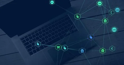 Image of web of connections with icons floating over a laptop computer lyin.. Stock Photos