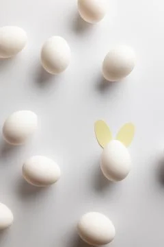 Image of white easter eggs with bunny ears and copy space on white background Stockfoto's