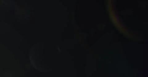 Image of white light with beam and prismatic lens flare on black background 库存插图