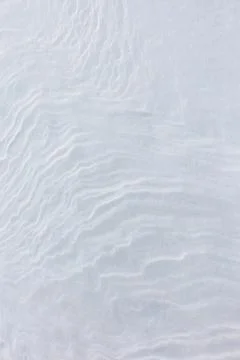 The image is of a white sandy beach with a wave pattern 스톡 사진