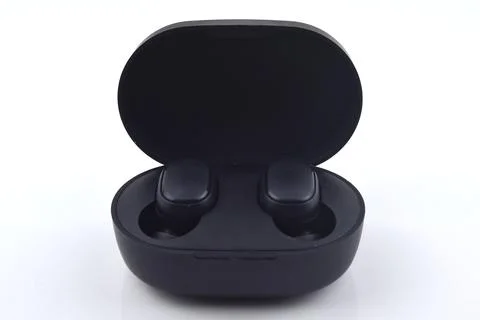 An image of wireless earbud isolated on white background. Wireless earbud use Stock Photos