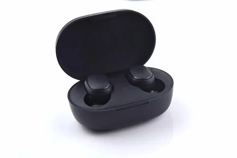 An image of wireless earbud isolated on white background. Wireless earbud use Stock Photos