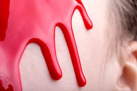 Image of woman's face with draining red paint, close-up Stock Photos