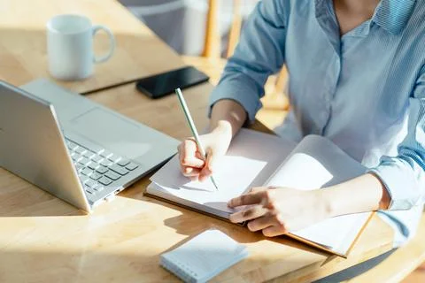 Image of woman's hand taking notes and making plans Stock Photos
