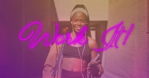 Image of work it over happy african american woman listening music during 写真素材