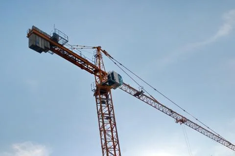 Image of a working construction crane on a blue sky background Stock Photos
