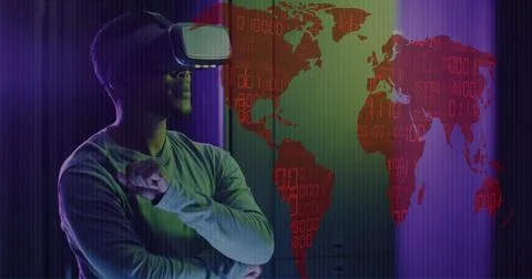 Image of world map and data processing over man wearing vr headset and computer Stock Photos
