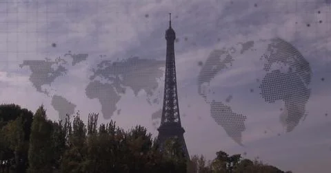 Image of world map and spinning globe against view of eiffel tower Stockfoto's