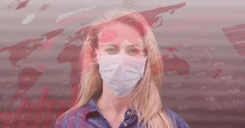 Image of world map and statistic data over caucasian female wearing face mask Foto stock