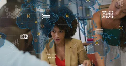 Image of world map over diverse business people in office Stock Photos