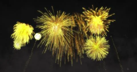 Image of yellow fireworks exploding on black background Stock Photos