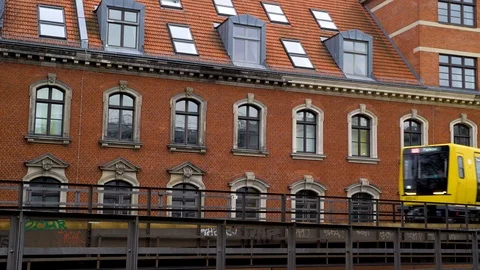 Image of a yellow tram passing in front of brick building, Berlin, Germany. Stock Footage 105589152
