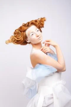 Image of a young beautiful red-haired woman. Young woman with an unusual Stock Photos