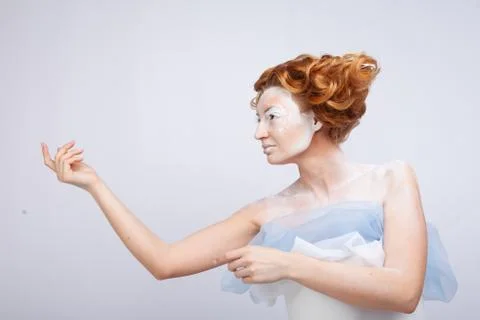 Image of a young beautiful red-haired woman. Young woman with an unusual Stock Photos
