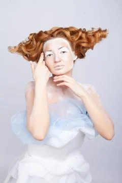 Image of a young beautiful red-haired woman. Young woman with an unusual Stock Photos