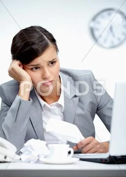 Image of young employer looking at laptop with troubled expression Stock Photos