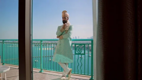 Image Of Young Man In Clothes In The Arabic Style. He Stands On The Balcony Of Vídeos de archivo 153772871
