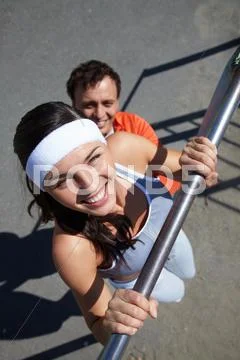 Image of young man doing physical exercise on sports ground Stock Photos