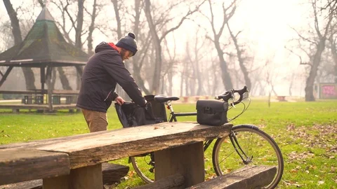 Image of young man packing to a bicycle touring trip in a park, Croatia. Stock Footage 127218885