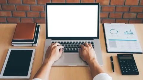 Image of Young man working in front of the laptop looking at screen with a cl Stock Photos