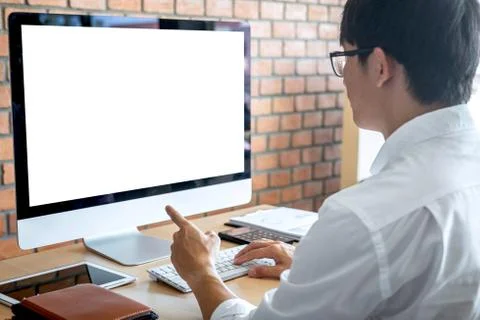 Image of Young man working in front of the computer laptop looking at screen Stock Photos