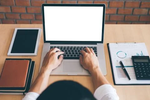 Image of Young man working in front of the laptop looking at screen with a cl Foto stock