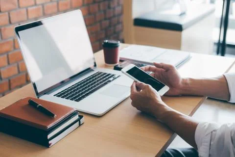 Image of Young man working in front of the laptop looking at screen with a cl Stock Photos