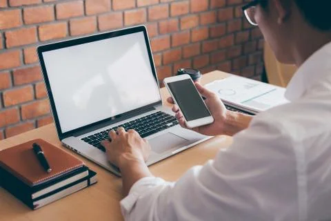 Image of Young man working in front of the laptop looking at screen with a cl Stock Photos