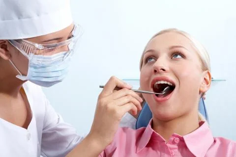 Image of young woman during inspection of oral cavity with help of mirror Stock Photos