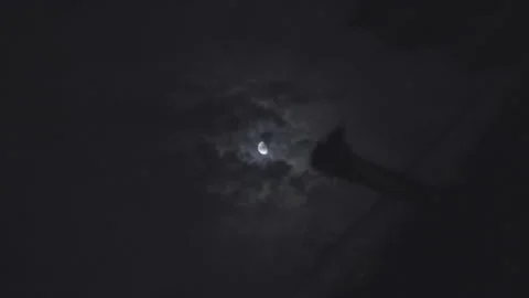 İmages of the moon moving through barbed wire on a dark cloudy night Stock Footage 314803602