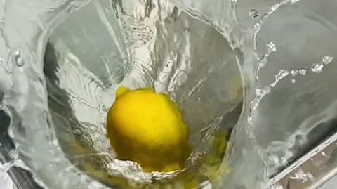IMG 2680Slow Motion Lemon Falling into Water, Citrus Splash in Kitchen Sink Stock Footage 337785199