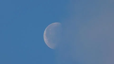 IMG 8060Moon in the blue sky with clouds, closeup of photo. Foto stock
