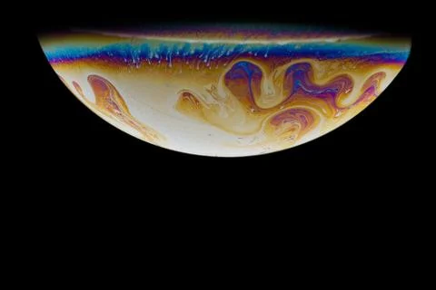 Imitation of an unknown planet. Soap bubble. Close-up. Black background. Stock Photos