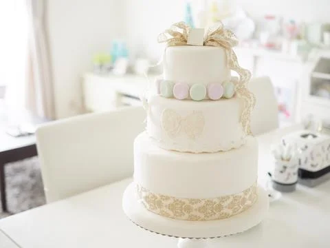 An imitation wedding cake coordinated with macaroons. Stock Photos