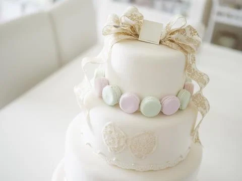 An imitation wedding cake coordinated with macaroons. Stock Photos