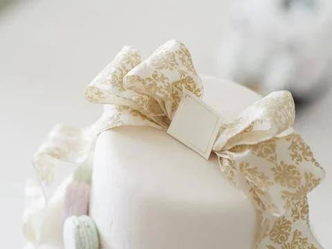 An imitation wedding cake coordinated with macaroons. Stock Photos