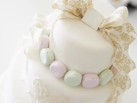 An imitation wedding cake coordinated with macaroons. Stock Photos