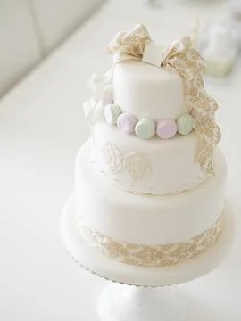 An imitation wedding cake coordinated with macaroons. Stock Photos